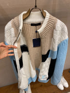 Louis Vuitton knit sweater on hanger with cream, black, and light-blue chevron design