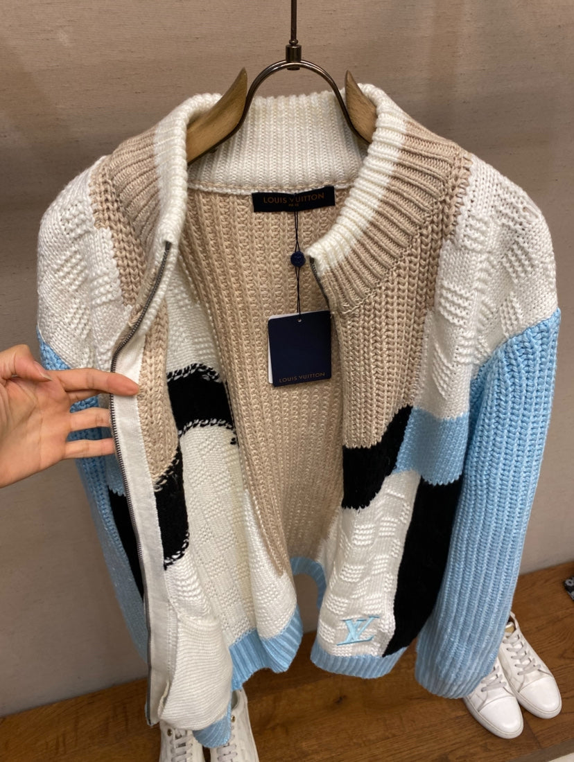 Louis Vuitton knit sweater on hanger with cream, black, and light-blue chevron design
