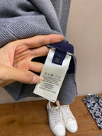 Gray hoodie neckline with brand label tag