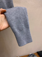 Gray ribbed cuff sleeve of a pullover hoodie