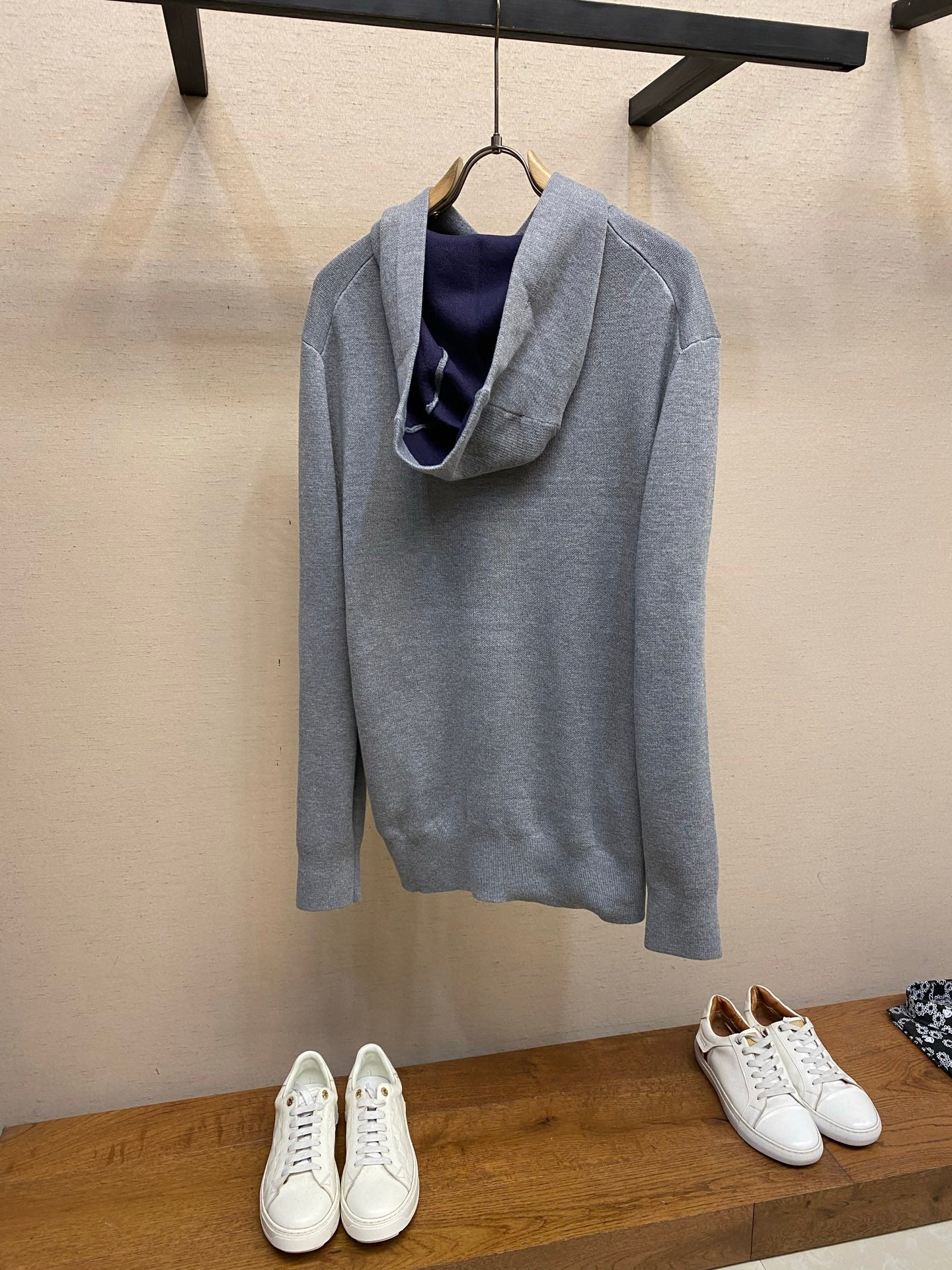 Gray pullover hoodie with hood and inner navy lining, front logo script, long sleeves