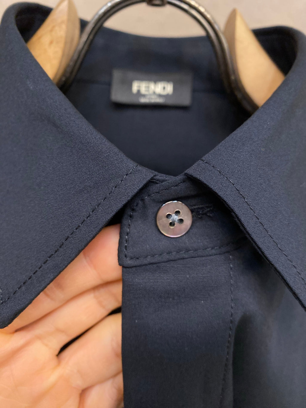 Fendi long-sleeve button-up shirt placket with dark navy button and collar