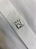 White shirt chest logo patch with outlined FF emblem stitching.