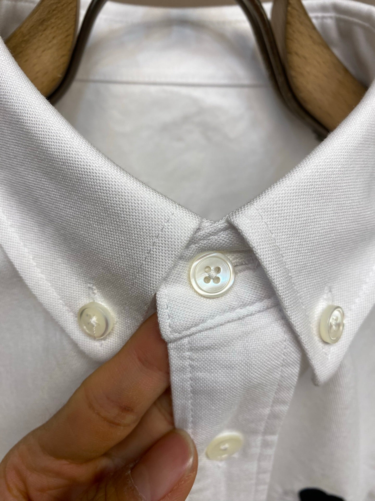 Amiri button-up shirt in white, pointed collar and button detail close-up