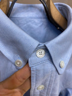 Light blue button-up shirt collar and button placket with white buttons