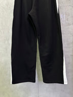 Black Balenciaga pants close-up, wide-leg silhouette and side seam
