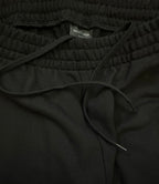 Black elastic-waist pants with Balenciaga inner label and drawstring