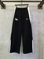 Black wide-leg pants with elastic waistband and NBA and Balenciaga logos