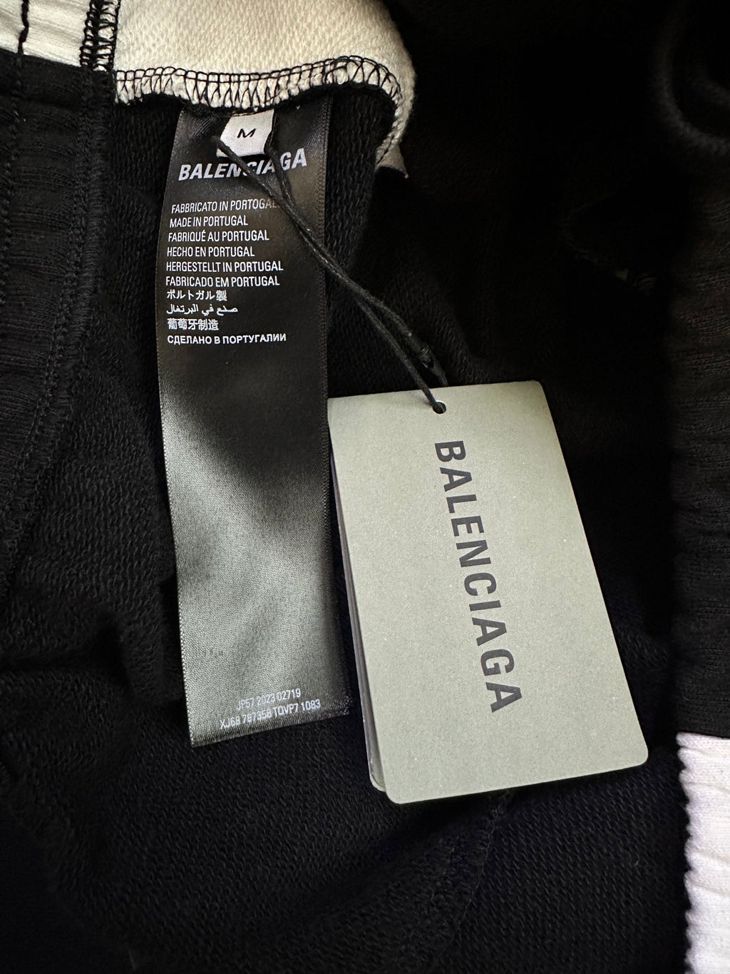 Black Balenciaga pants with care tag and swing size label near waistband