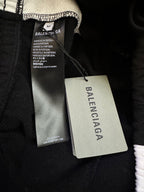 Black Balenciaga pants with care tag and swing size label near waistband