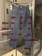 Blue denim jeans on display stand with belt loops and front button closure