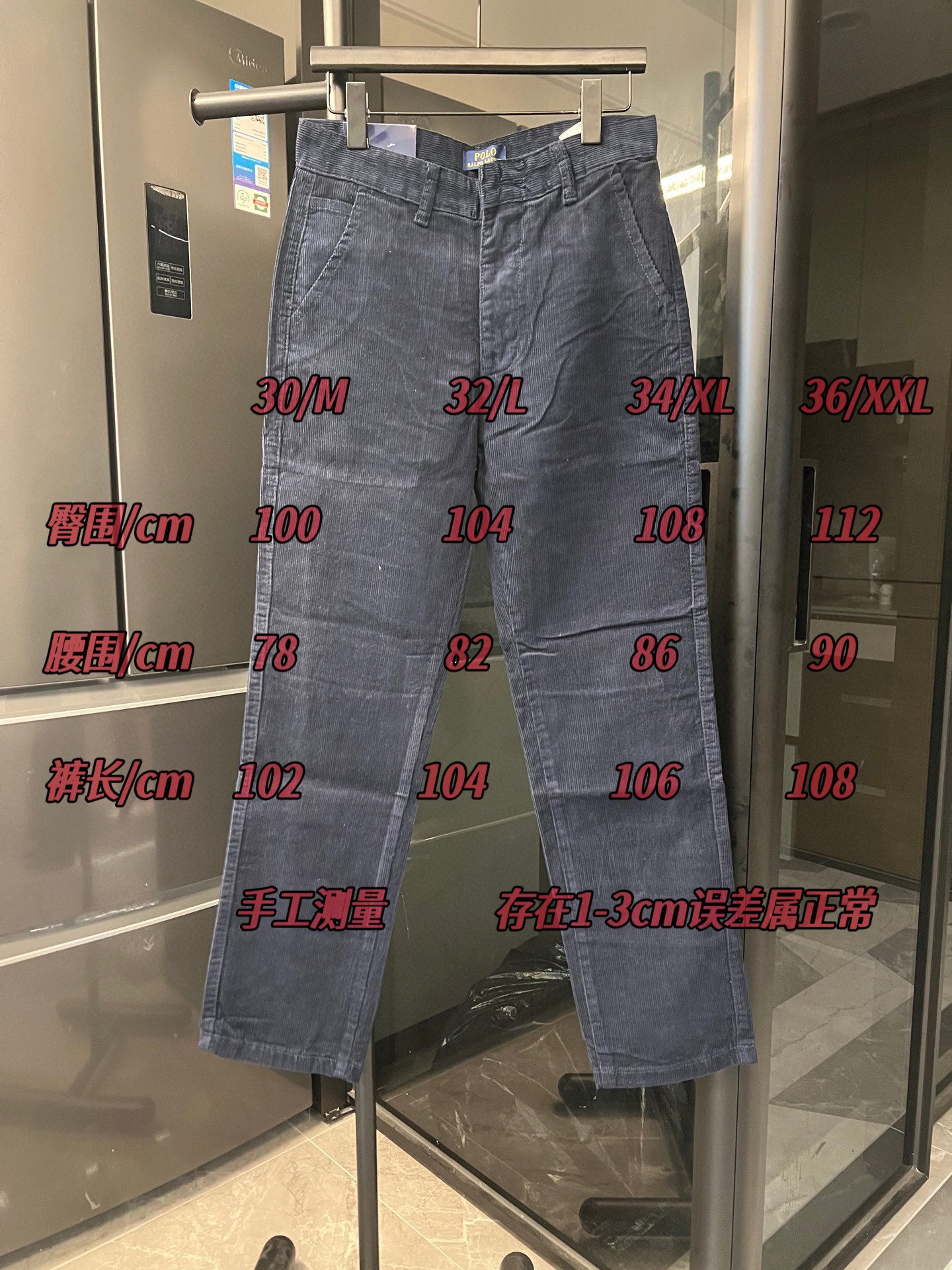 Blue denim jeans on display stand with belt loops and front button closure