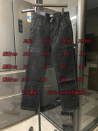 Dark corduroy jeans displayed on hanger with belt loops