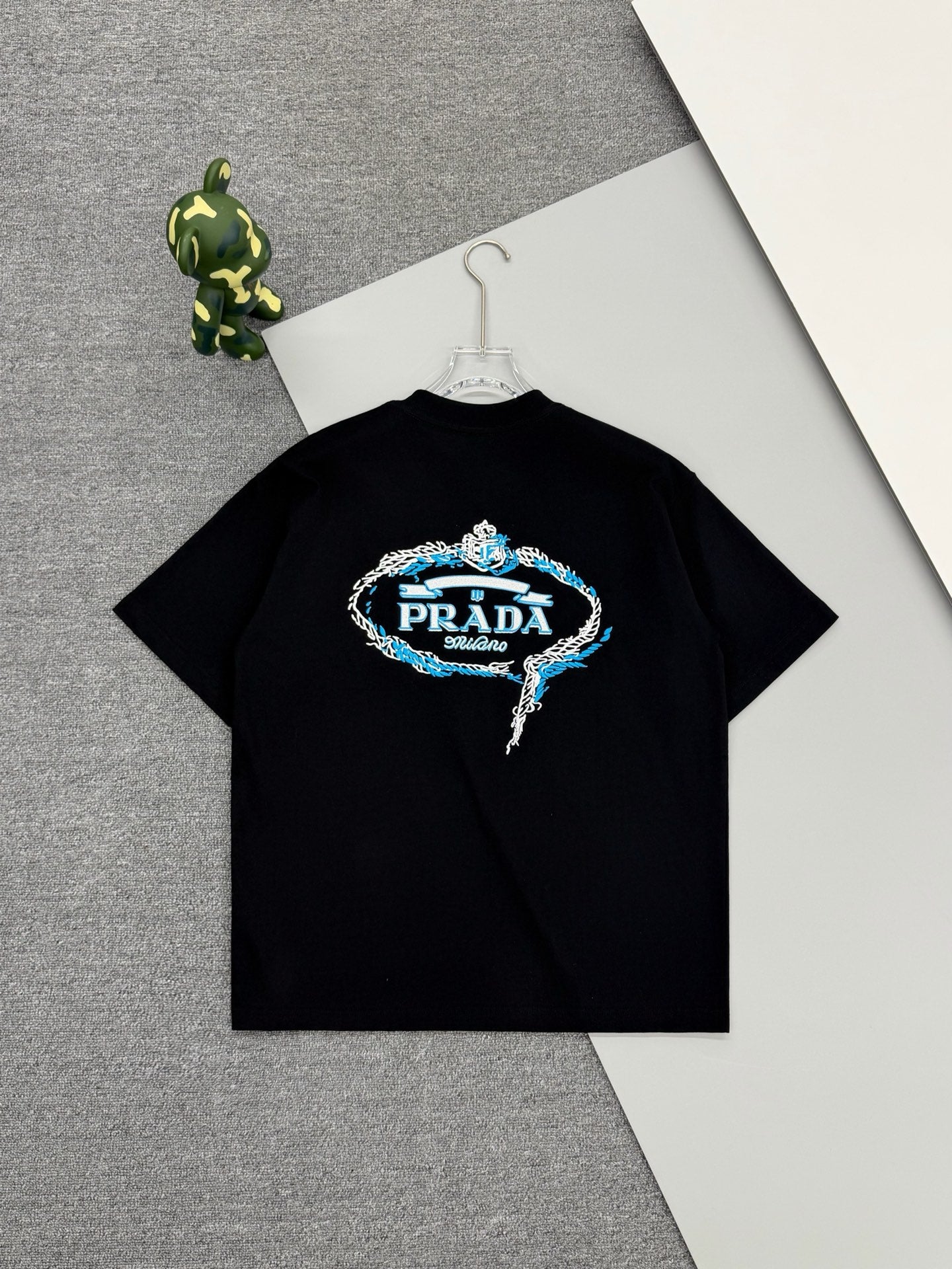 Black Prada short-sleeve T-shirt with blue embroidered logo graphic at center