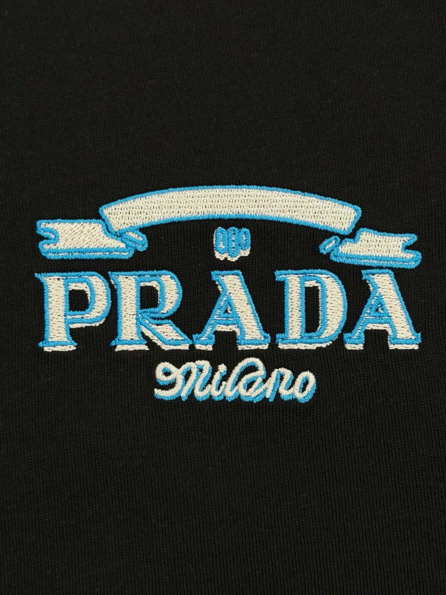 Black Prada Milano T-shirt with blue and white embroidered PRADA logo
