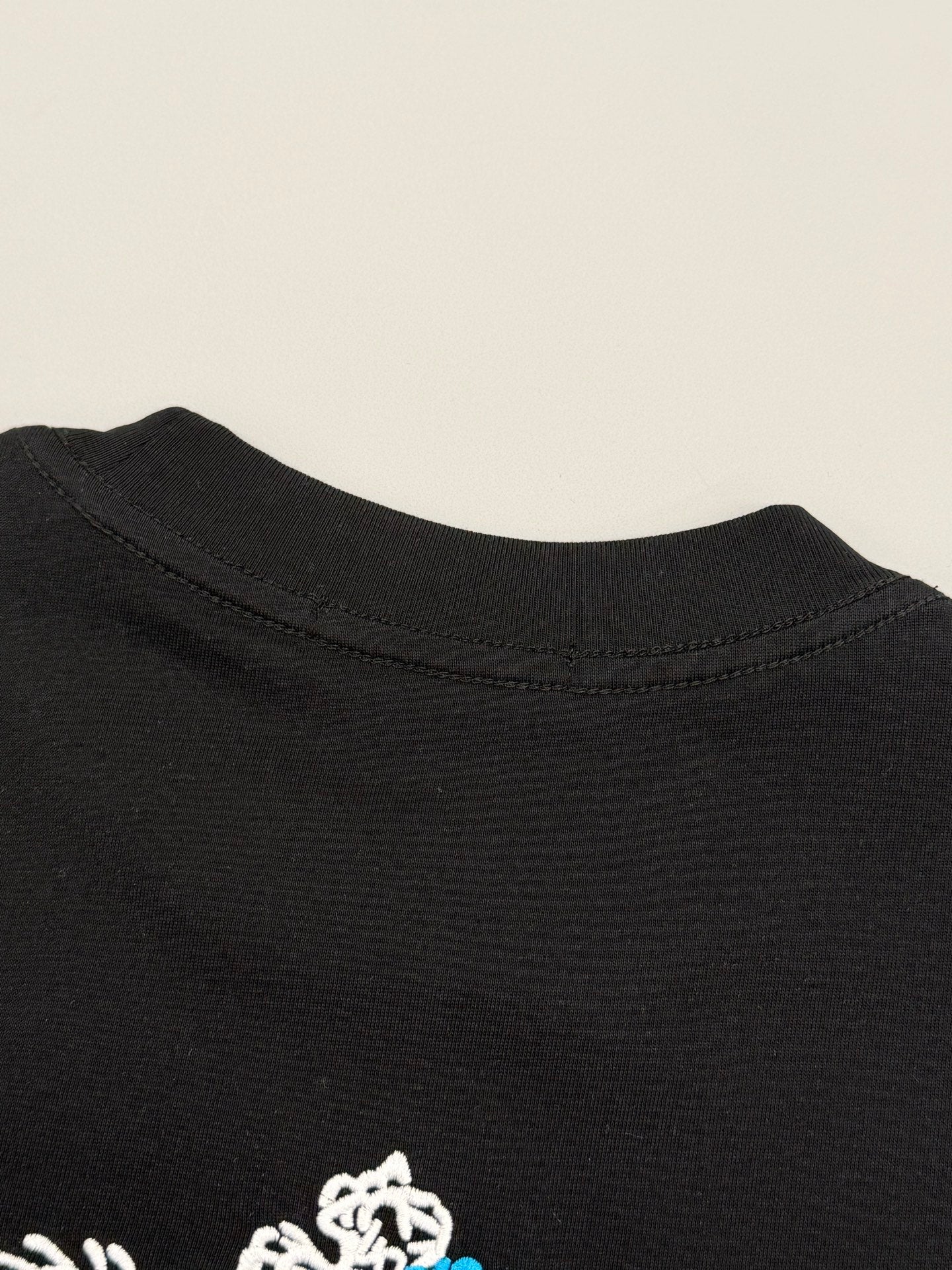 Black Prada T-shirt back collar with small white emblem detail