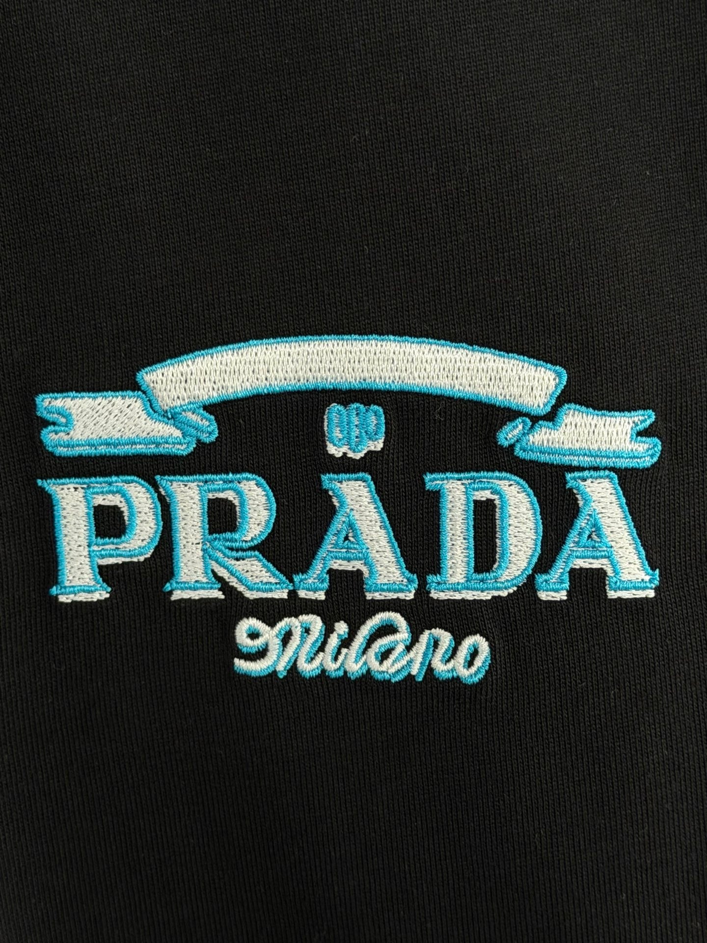 Prada Milano black T-shirt with blue PRADA Milano embroidered text