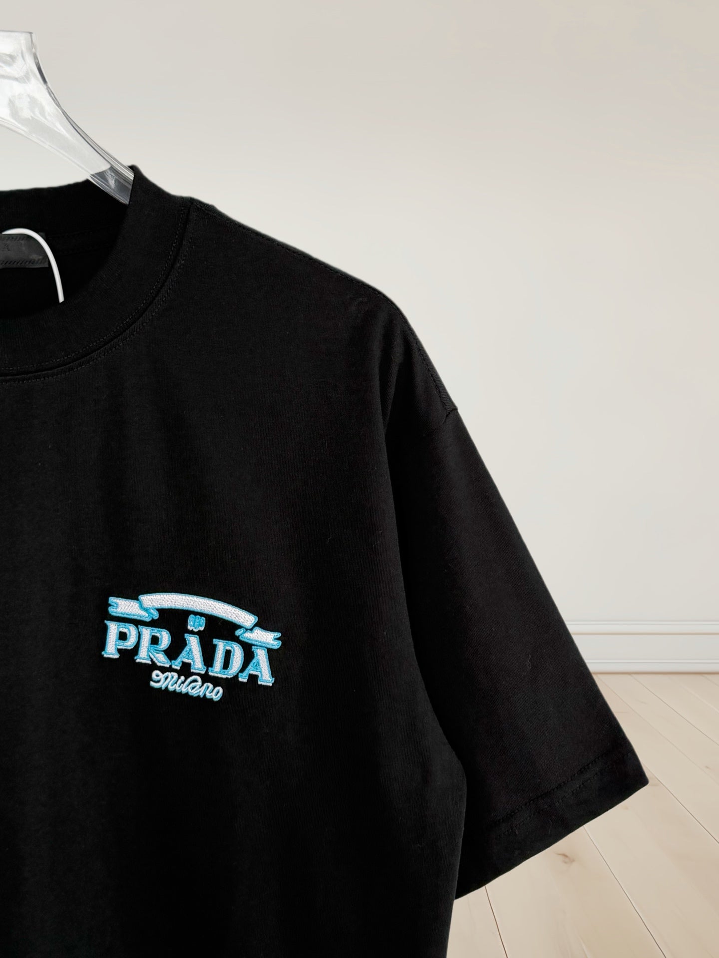 Prada Milano black short-sleeve T-shirt with small blue logo on sleeve
