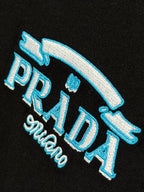 Prada Milano black T-shirt close-up of blue PRADA logo with Milano script