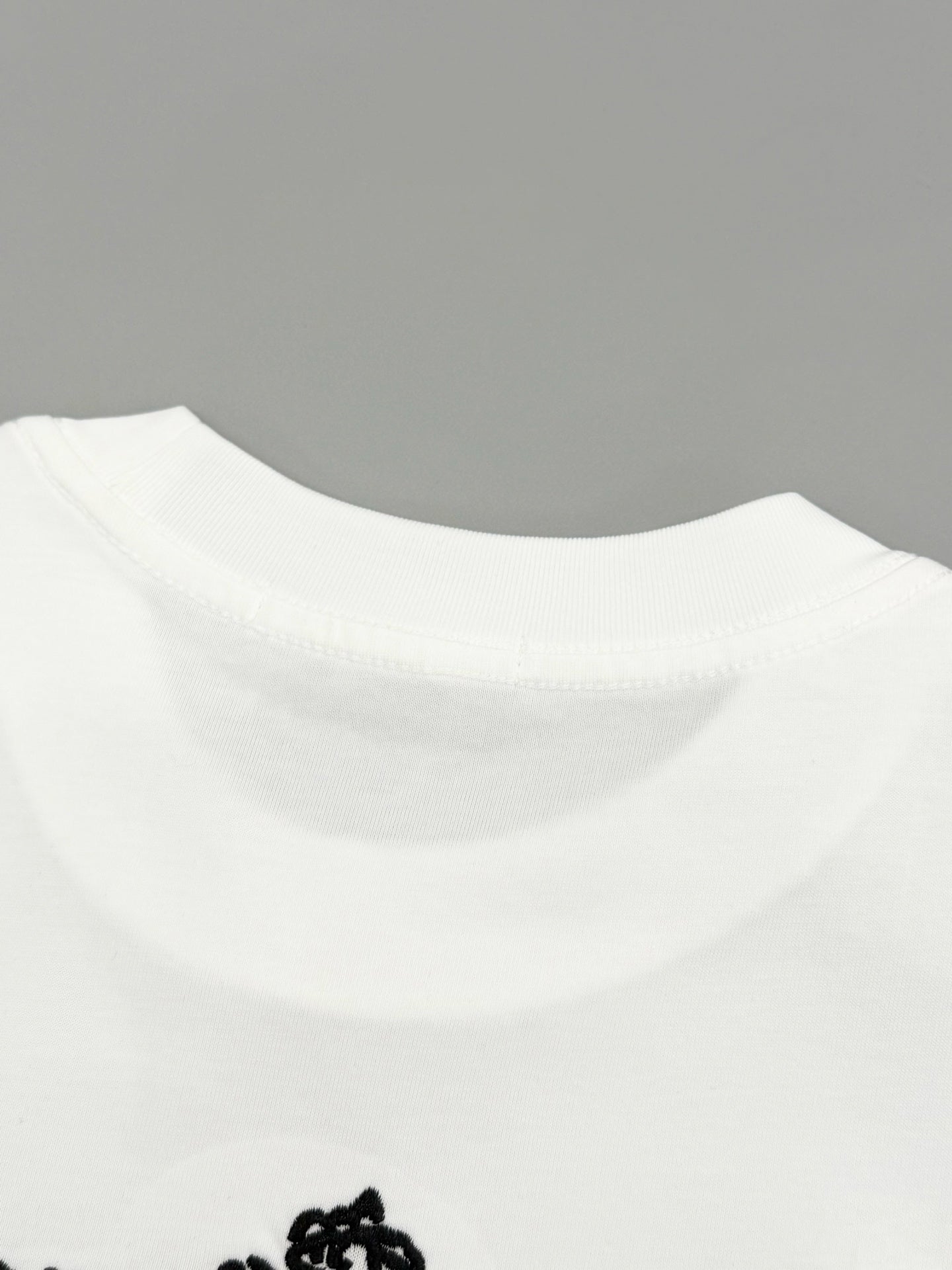 White T-shirt collar with visible stitching and relaxed neckline