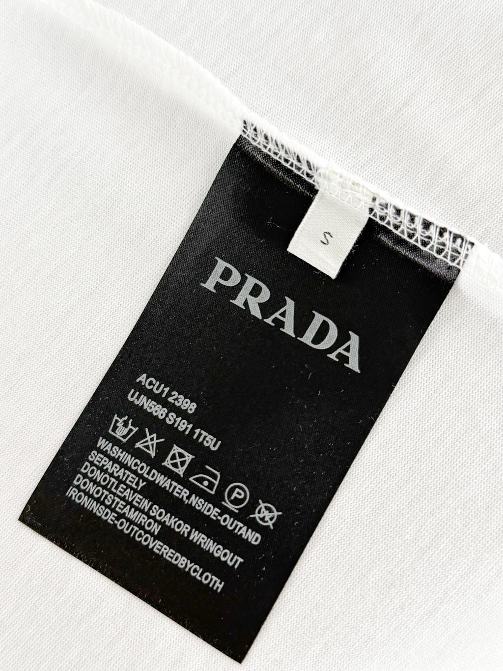 Prada T-shirt care label and size tag on inside seam