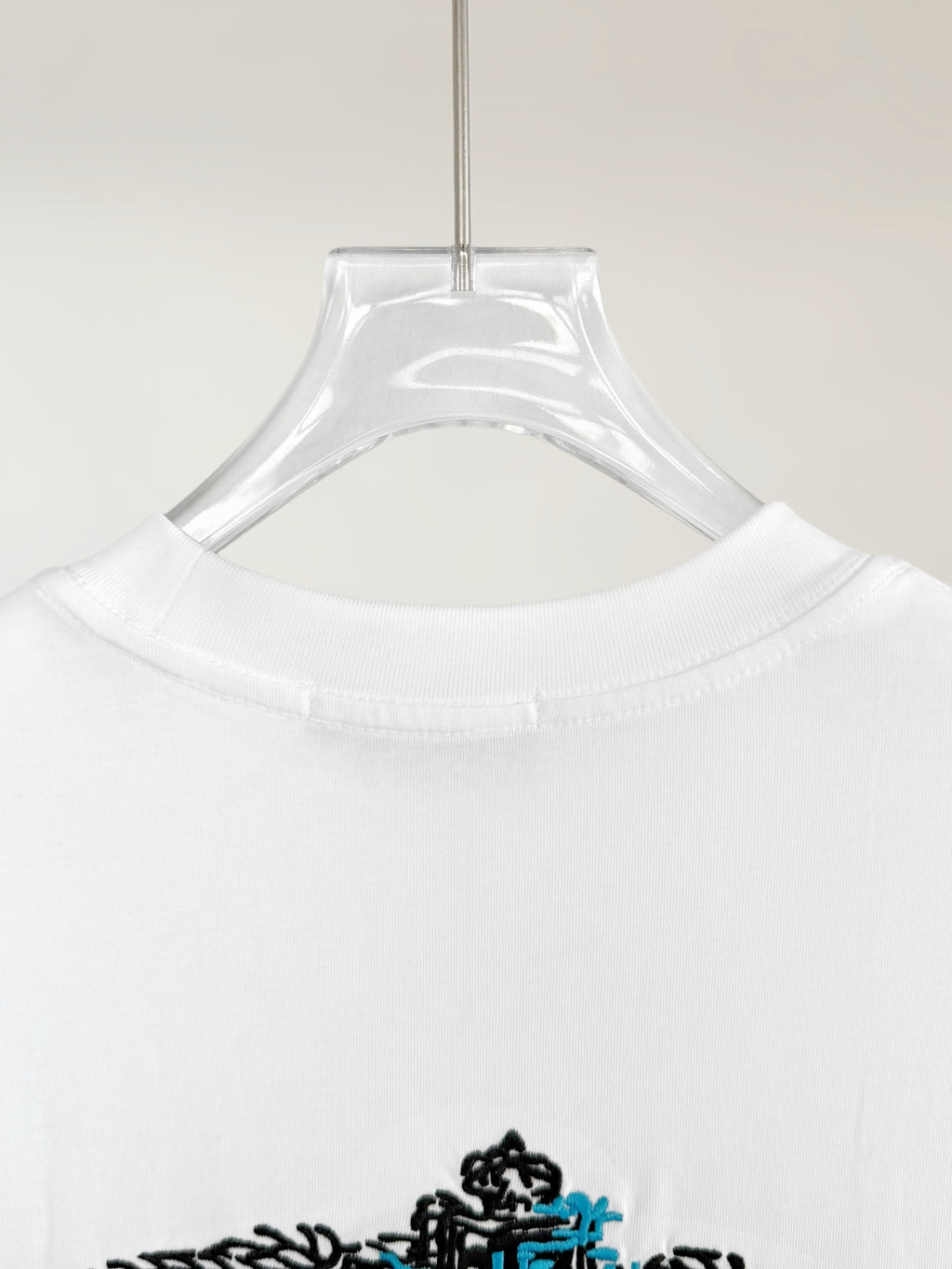 Prada T-shirt collar close-up with hanging tag