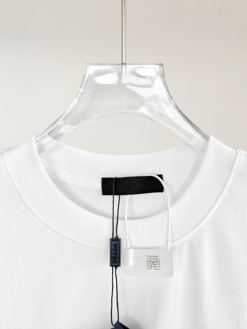 Prada T-shirt neckline with black inner neck label and white size tag