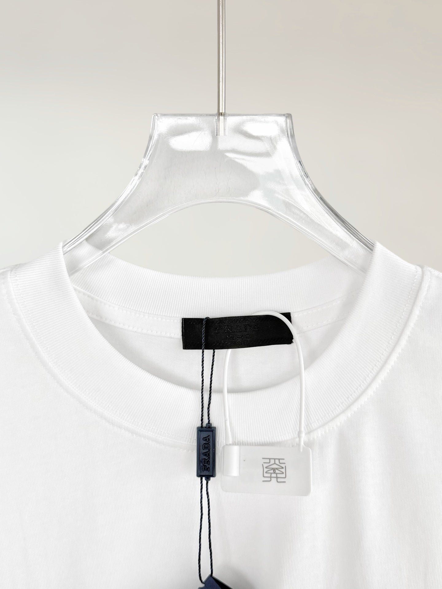 Prada T-shirt neckline with black inner neck label and white size tag