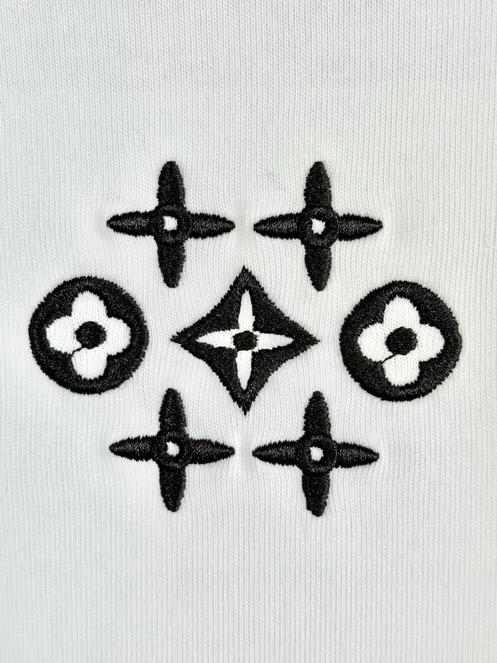 White knit fabric with black geometric flower and star pattern