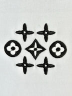 White knit fabric with black geometric flower and star pattern