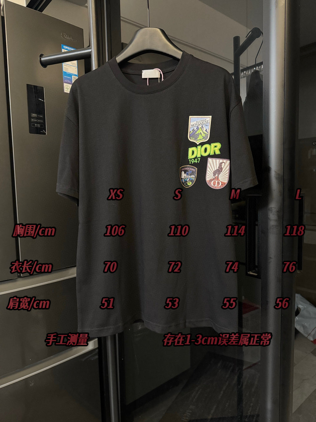 Front view of black crew-neck T-shirt with Dior patch graphics