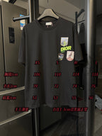 Front view of black crew-neck T-shirt with Dior patch graphics