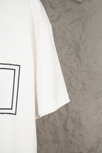 White short-sleeve T-shirt hem and side seam, with partial black graphic on left