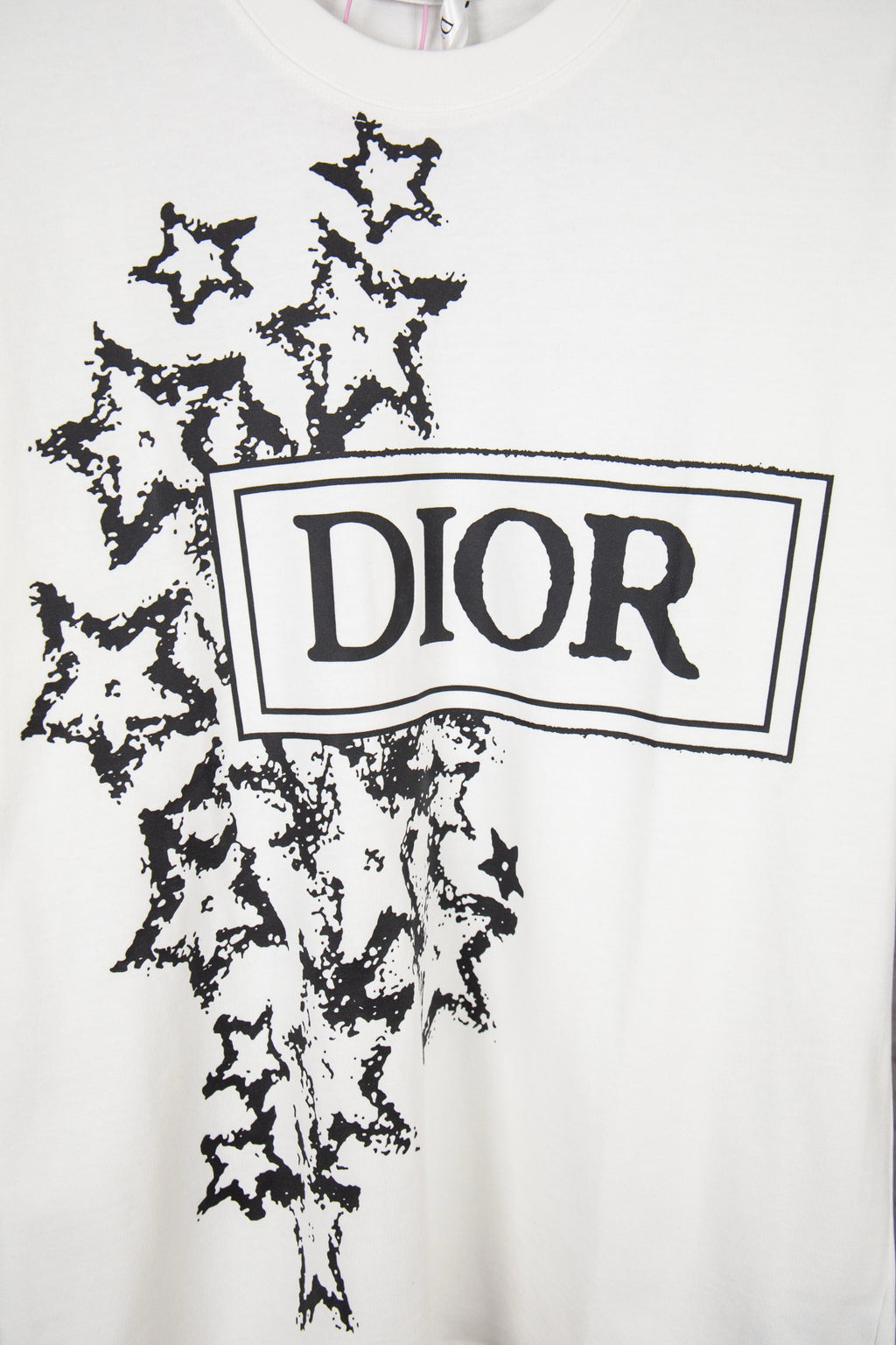 White short-sleeve T-shirt front with large black Dior logo and starburst print