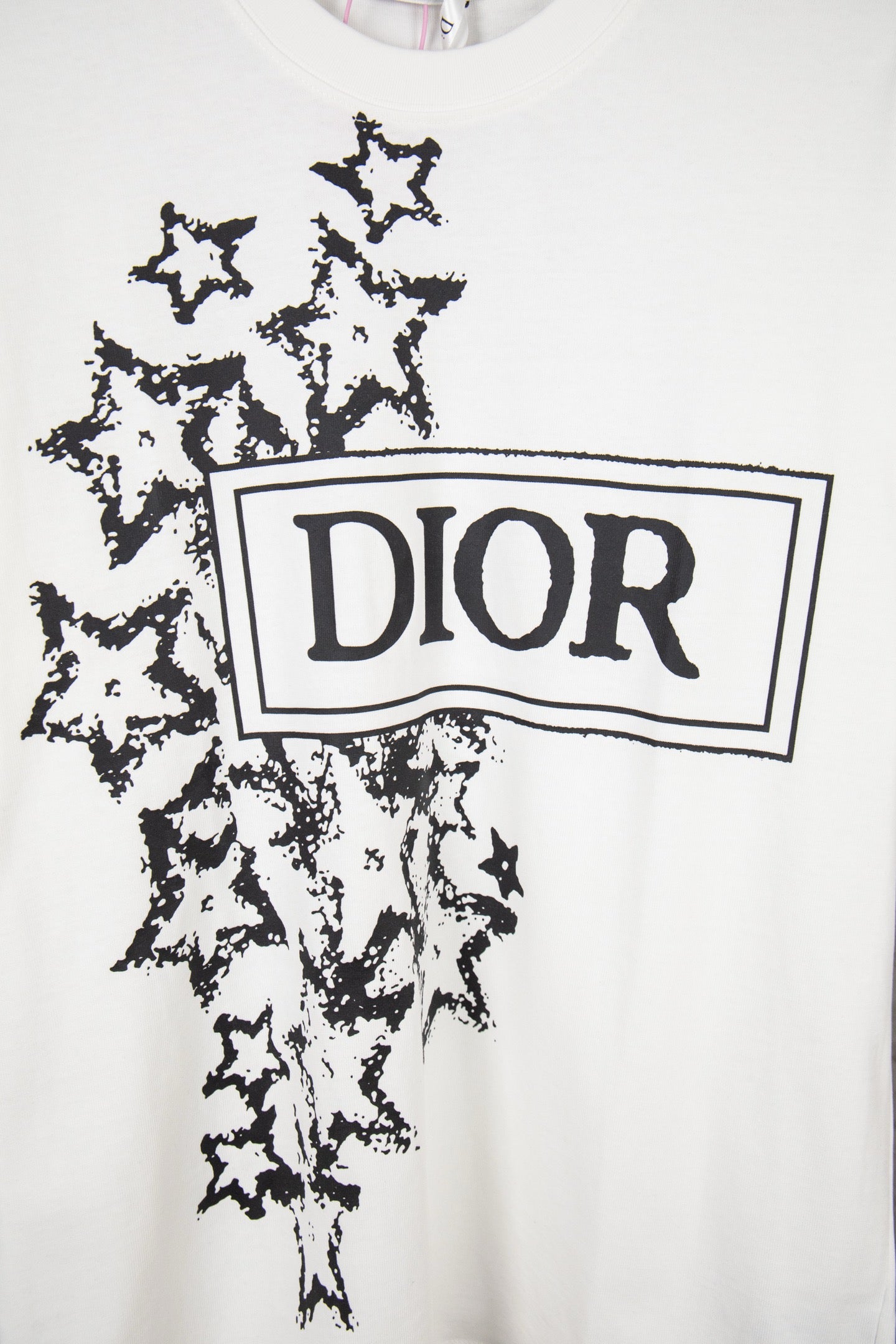 White short-sleeve T-shirt front with large black Dior logo and starburst print