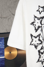 White short-sleeve T-shirt side view with black starburst graphic edge visible