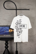 White short-sleeve T-shirt with black starburst graphic and Dior logo on front