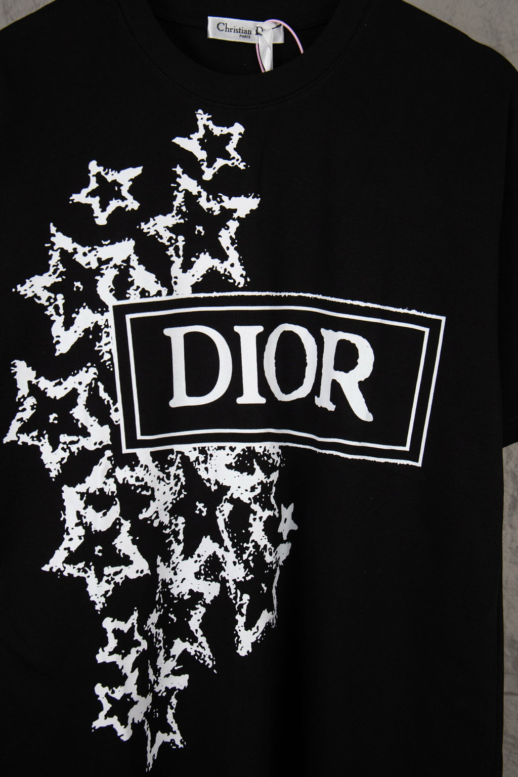 Black short-sleeve T-shirt with large white DIOR logo and starburst pattern