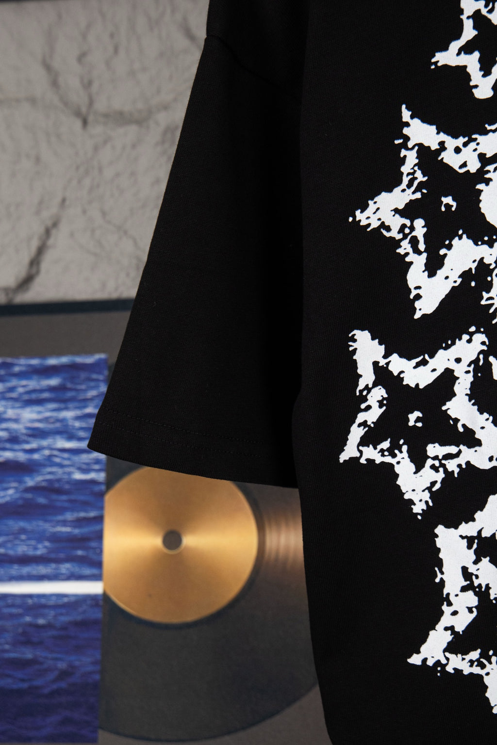 Black short-sleeve T-shirt hem and sleeve with partial white starburst graphic