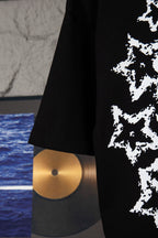 Black short-sleeve T-shirt hem and sleeve with partial white starburst graphic