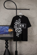 Black short-sleeve T-shirt with white star graphic and DIOR logo patch on chest