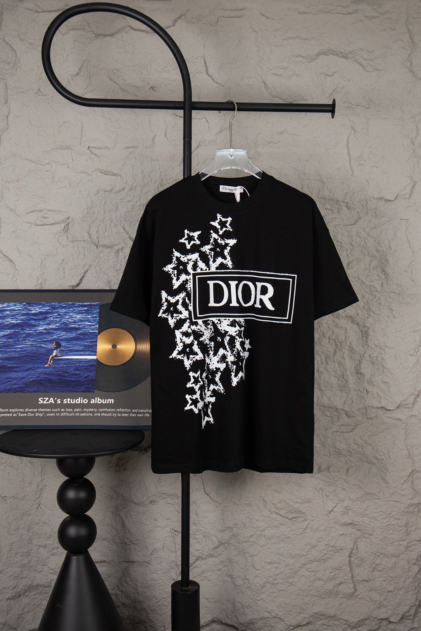 Black short-sleeve T-shirt with white star graphic and DIOR logo patch on chest