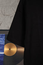Black short-sleeve T-shirt with visible side seam and curved hem