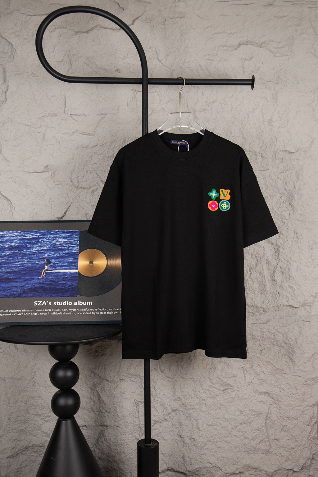 Black short-sleeve T-shirt with multicolor logo patch on chest