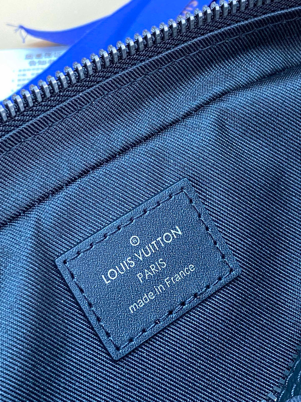 Louis Vuitton monogram bag interior label stitched near the zipper