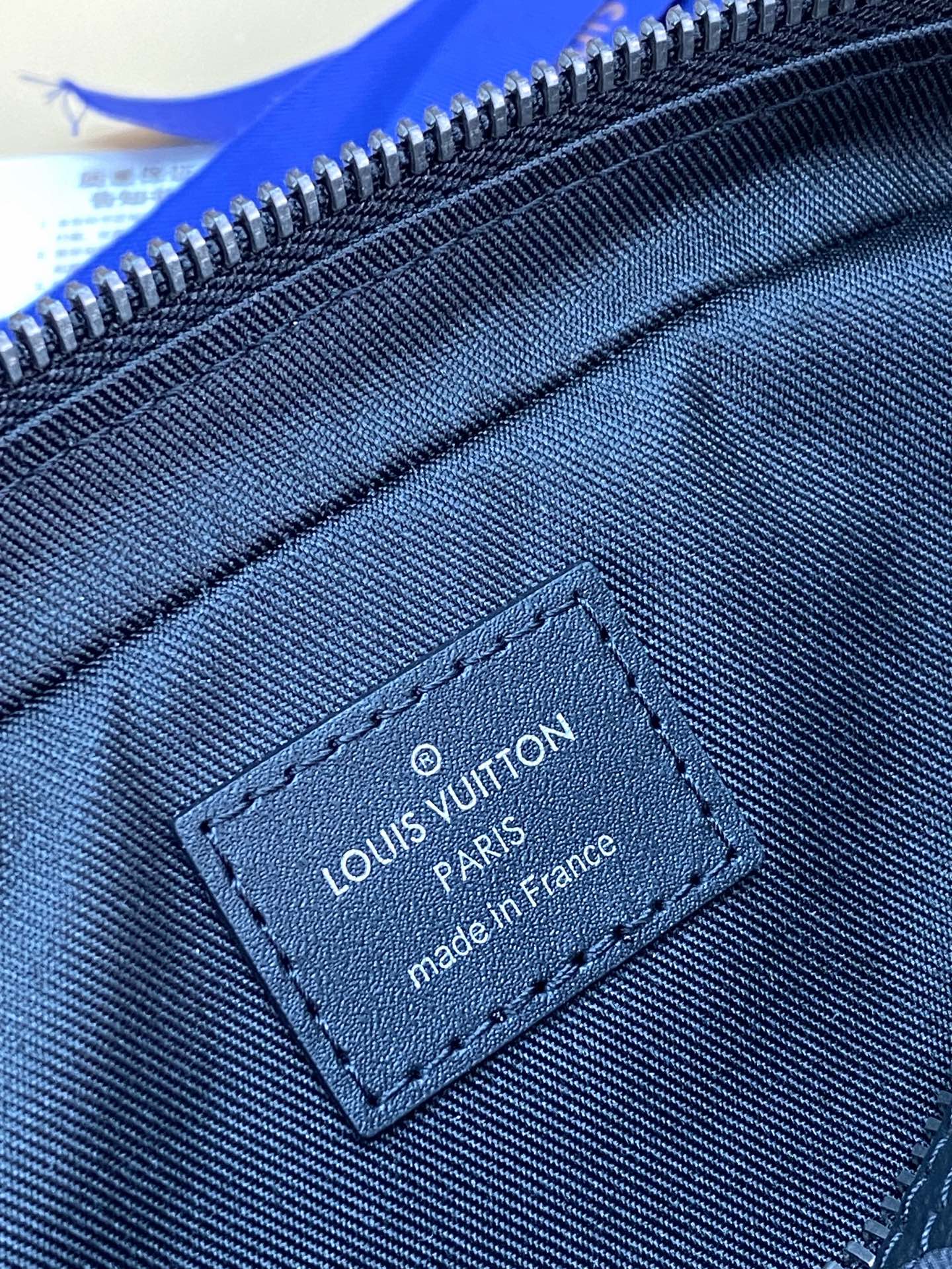 Louis Vuitton monogram bag interior label stitched near the zipper