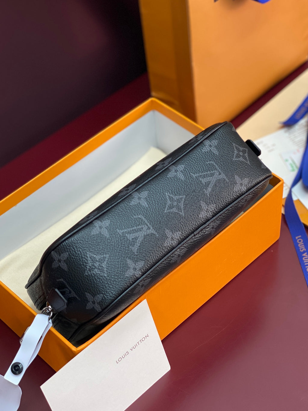 Louis Vuitton monogram crossbody bag, dark long strap and front zipper detail