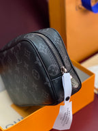 Small Louis Vuitton monogram bag with side seam, zip, and hanging tag