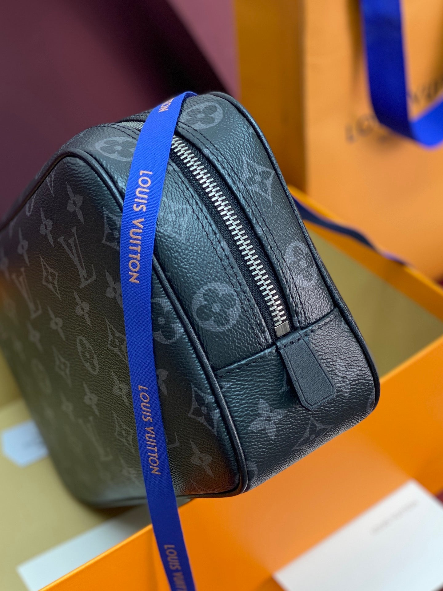 Louis Vuitton monogram toiletry bag, dark canvas, side profile with zipper