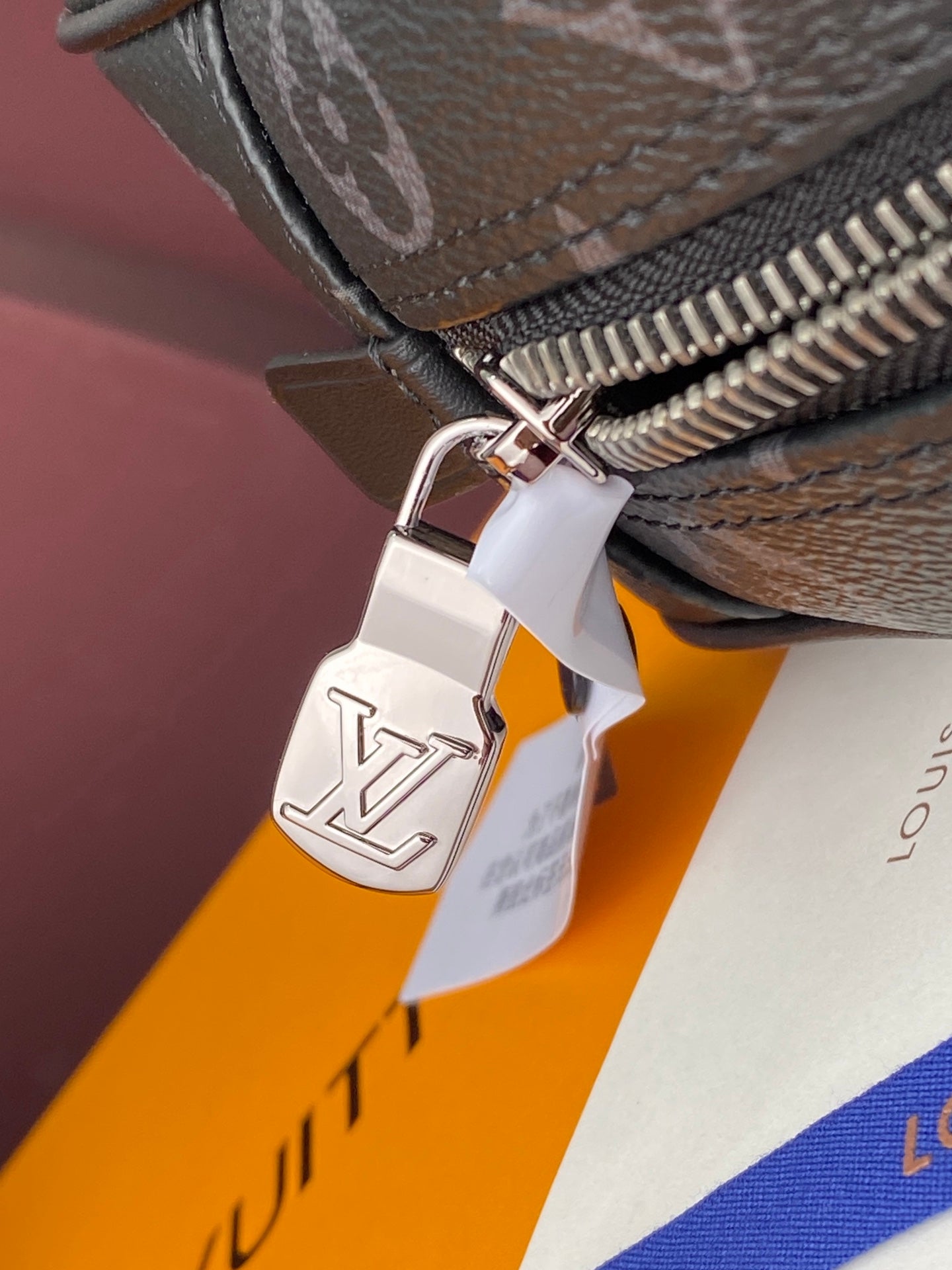 Louis Vuitton small men bag zipper pull with metal LV charm tag